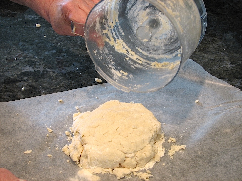 Turning out dough on to waxed paper in preparation for rolling it out