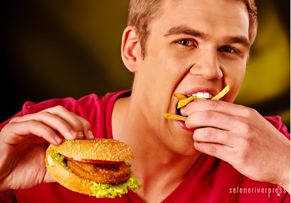 Teen with burger and fries