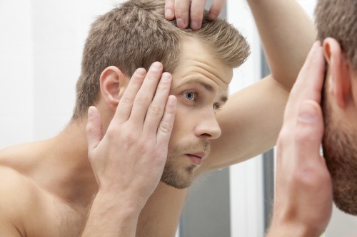 Man checking scalp