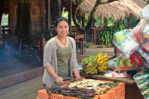 Young lady preparing grilled banana and sweet yam